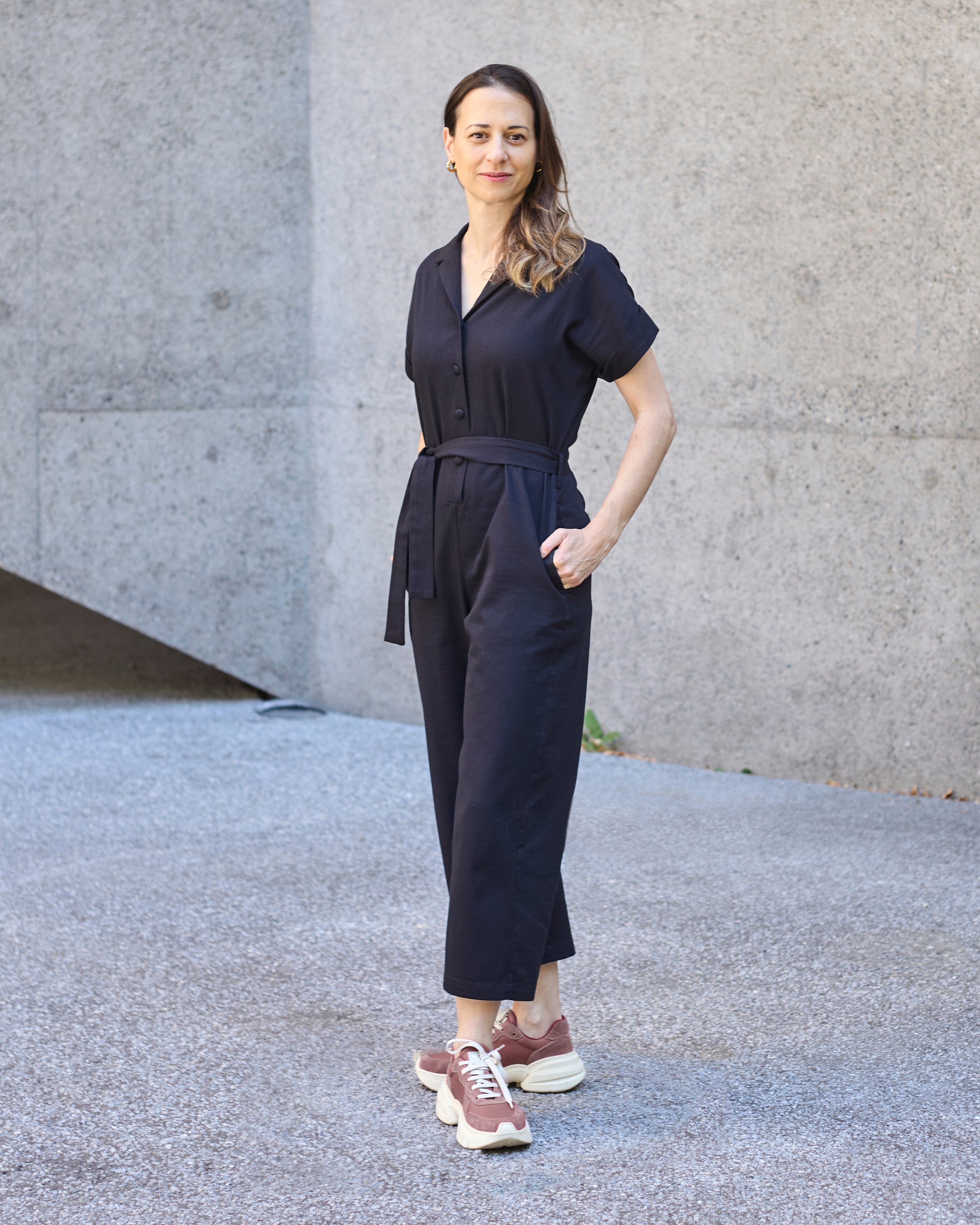 Side view of a petite model wearing the Black Jumpsuit.