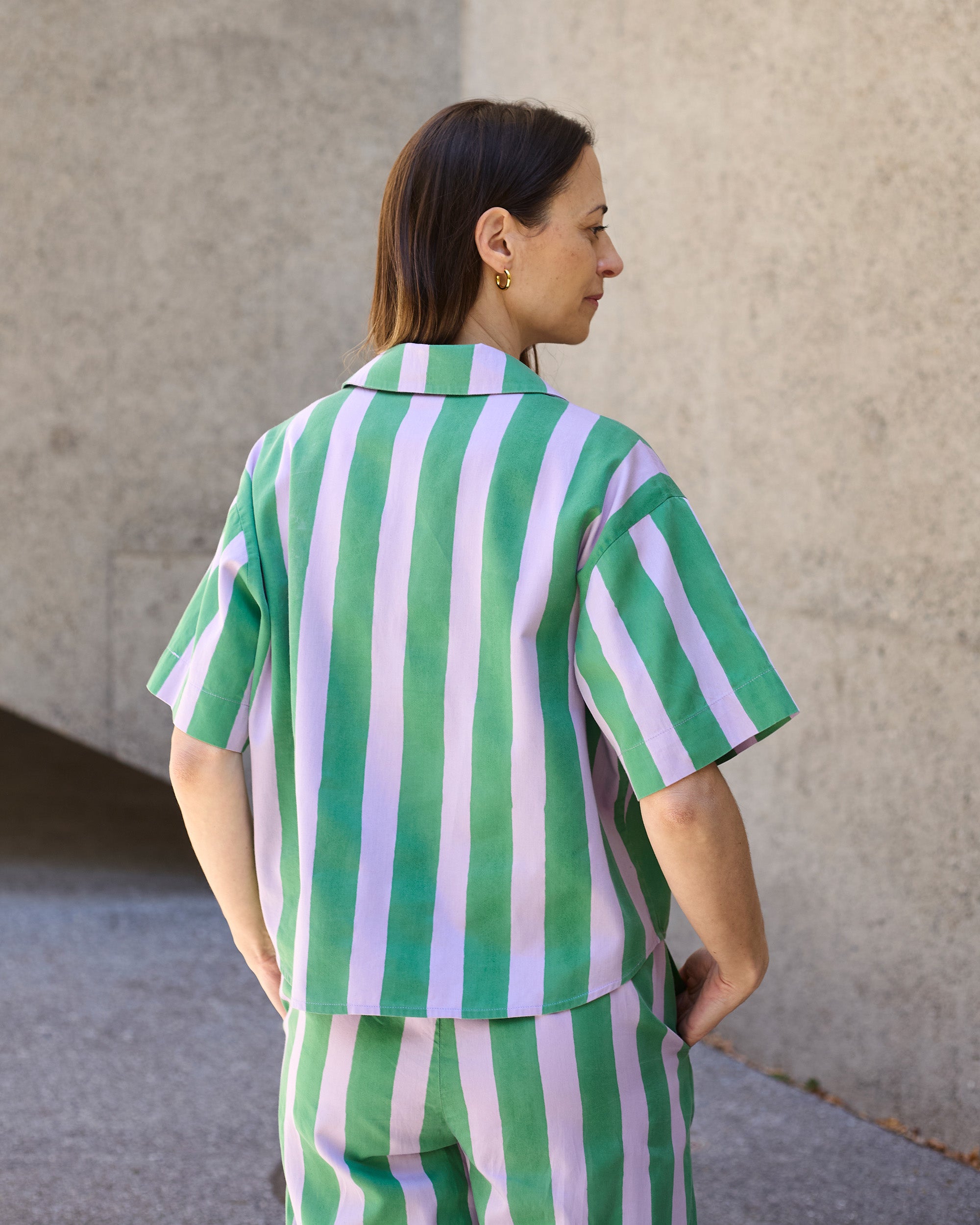 Back view of petite striped blouse in green and lilac blockprint organic cotton.