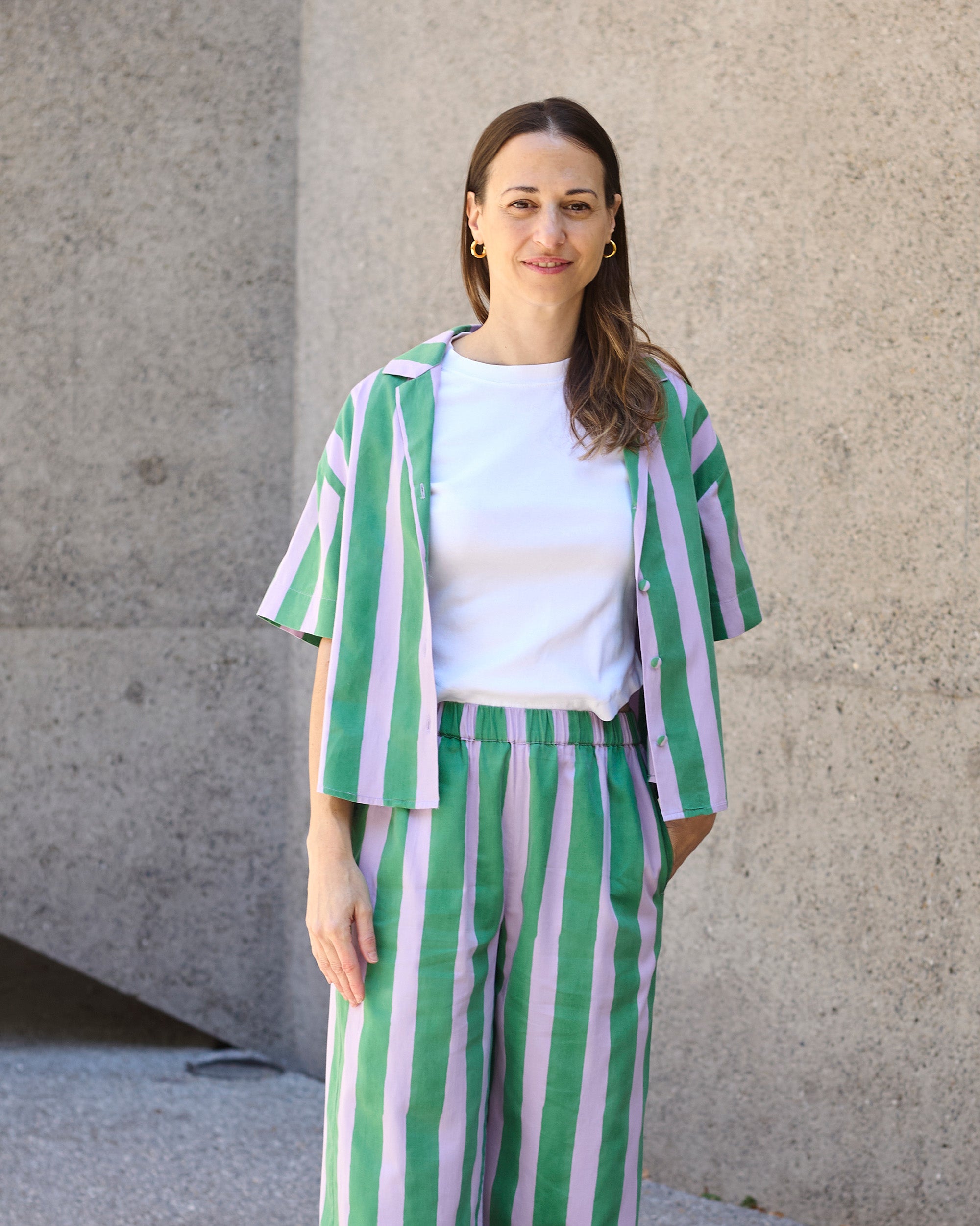 Close-up view of petite striped blockprint trousers with elasticated waistband in green and lilac stripes.
