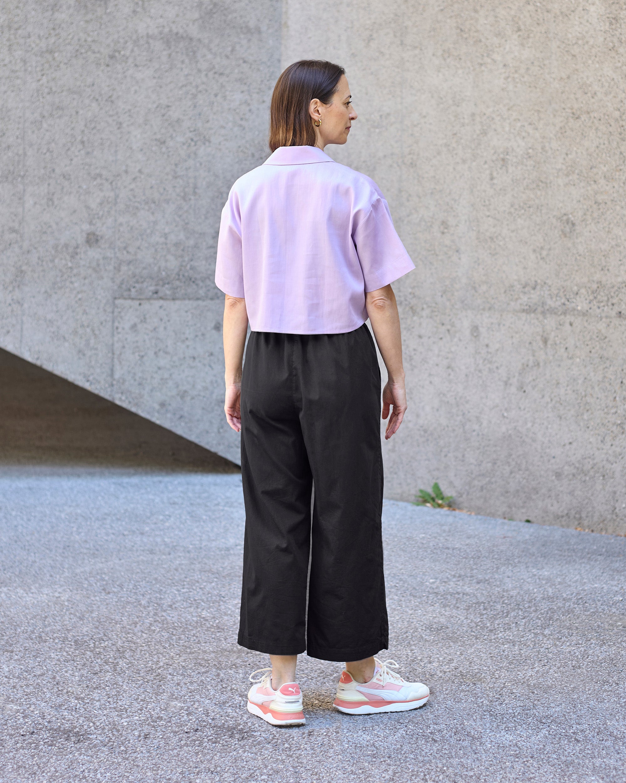 Back view of a petite model wearing the Wide Leg Trouser Black.