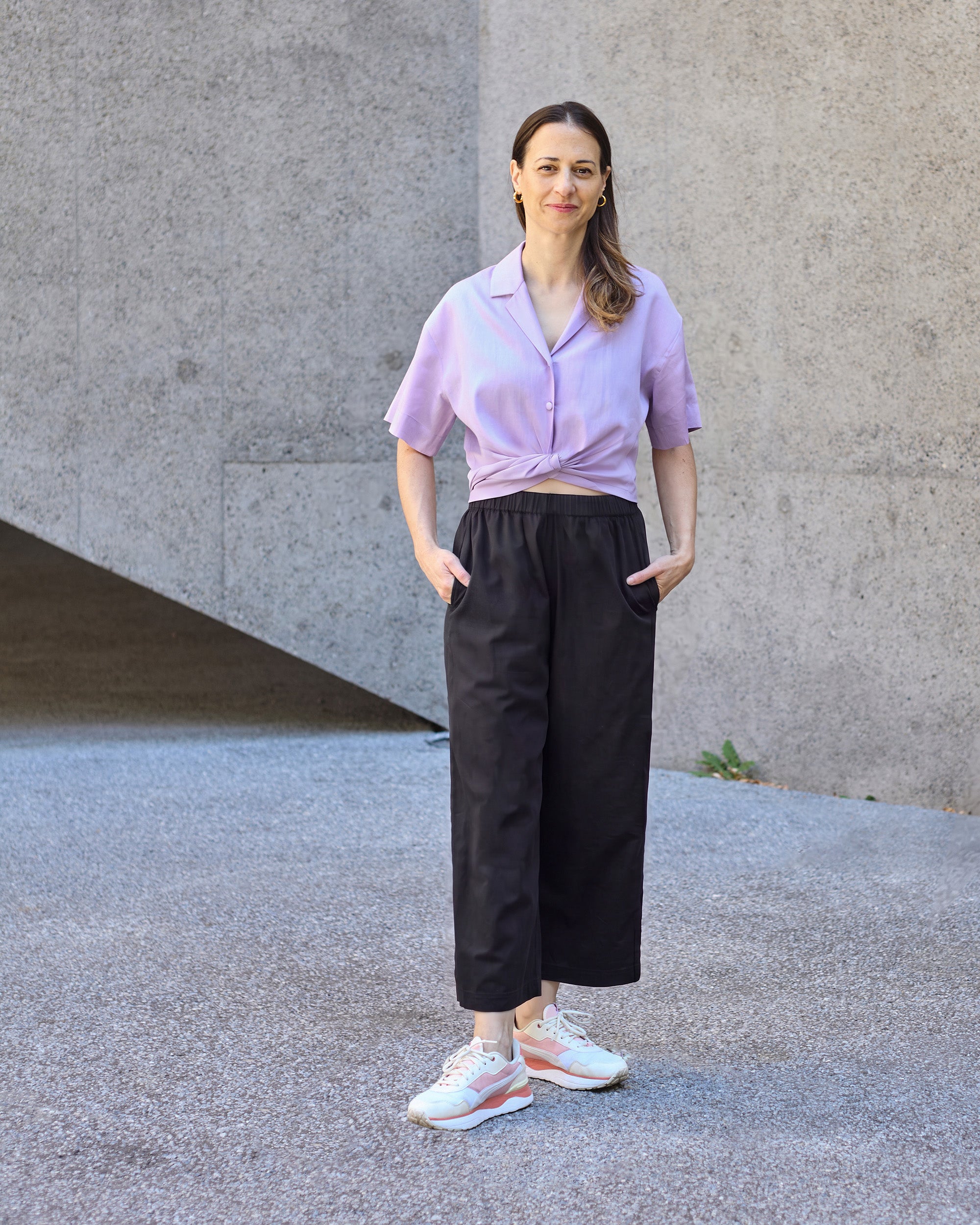 Front view of a petite model wearing the Wide Leg Trouser Black.