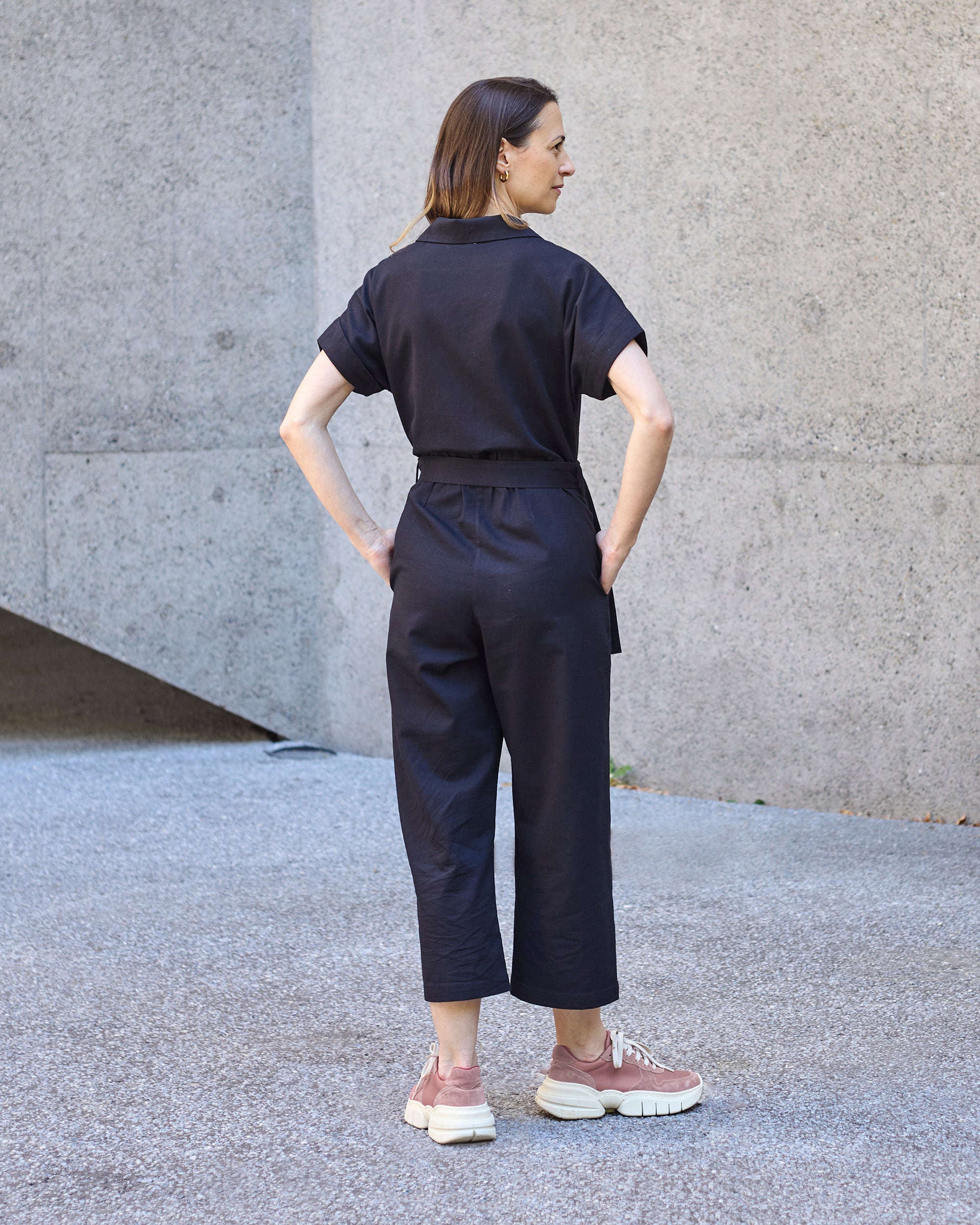 Back view of a petite model wearing the Black Jumpsuit.
