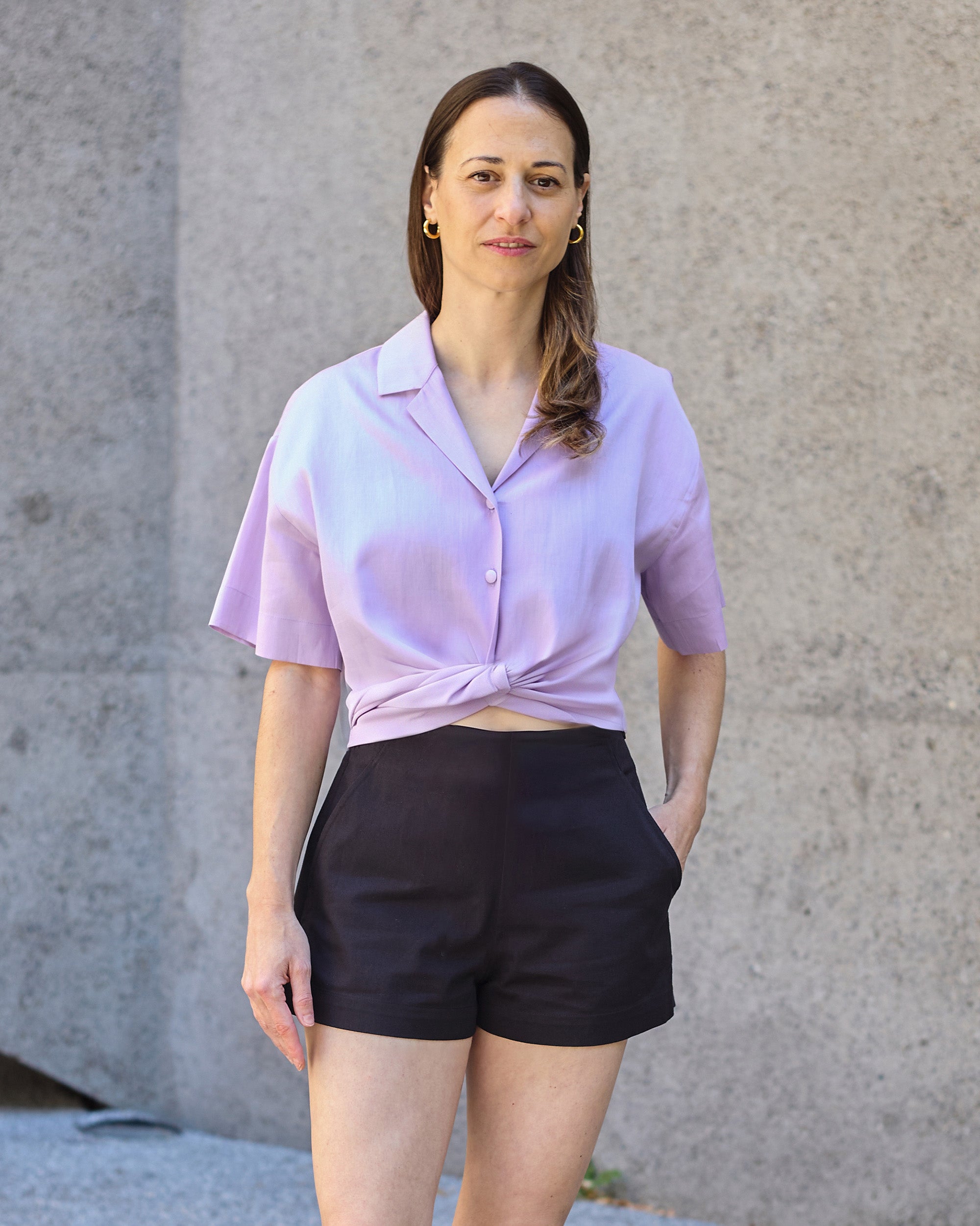 Front view of a petite model wearing the Black Shorts.
