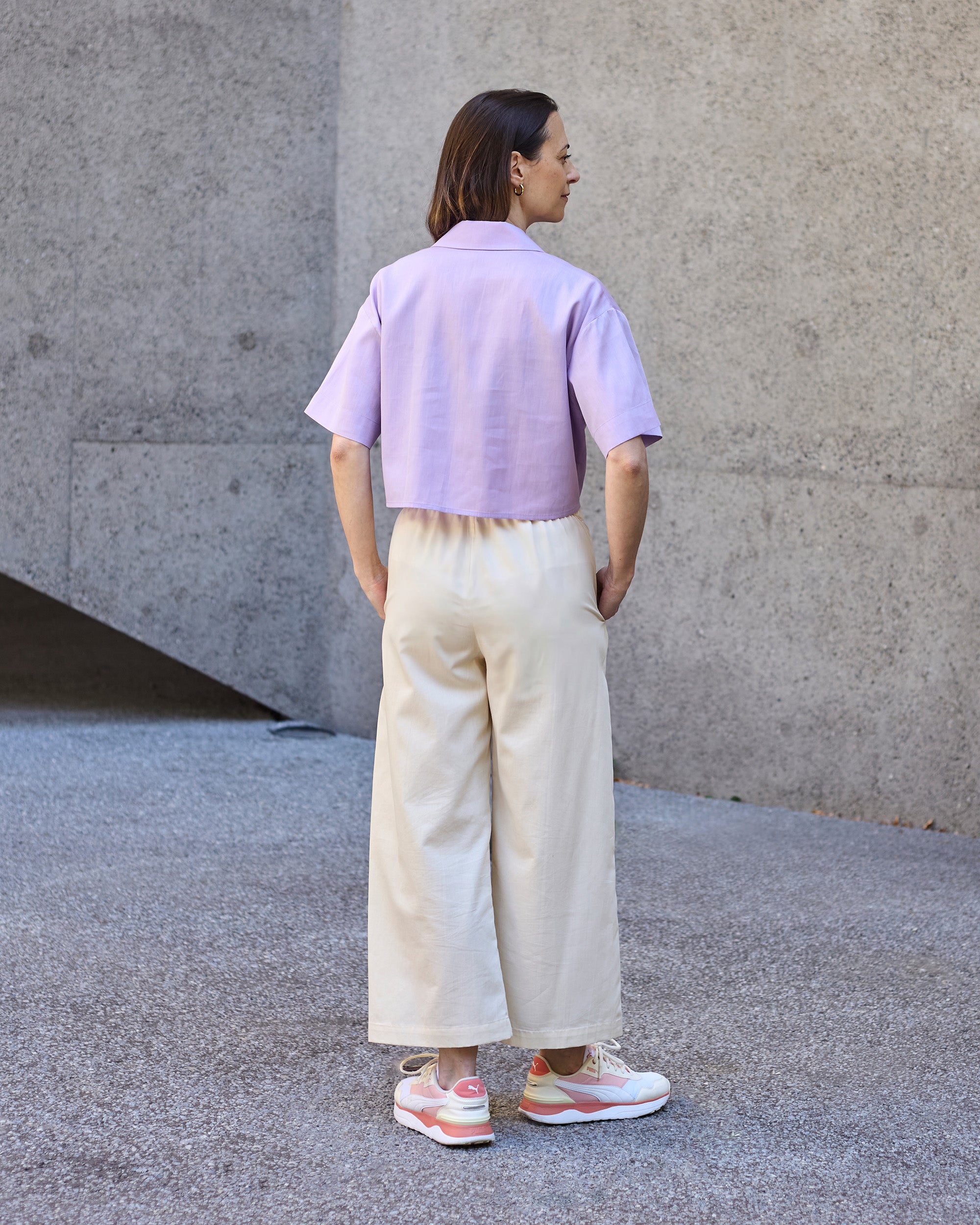 Back view of a petite model wearing the Wide Leg Trouser Ecru.